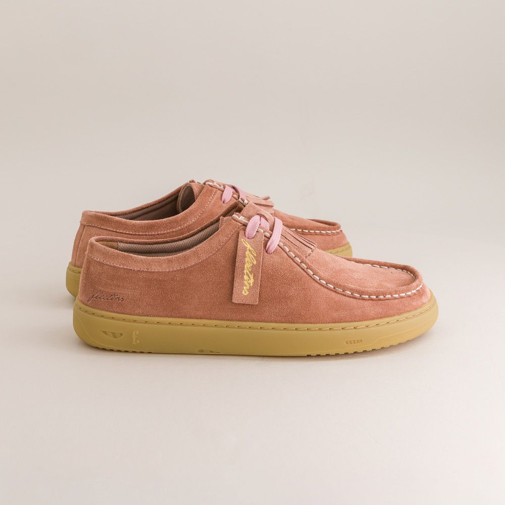 Pair of pink barefoot derbies with yellow soles on a light gray background