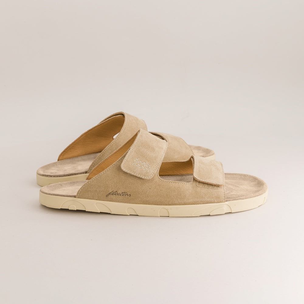 Beige barefoot sandals with a strap on a light gray background