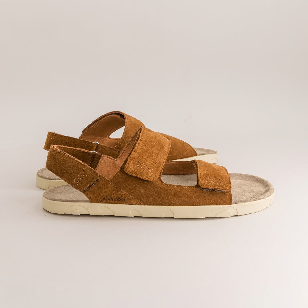 Brown barefoot sandals with white soles on a light gray background