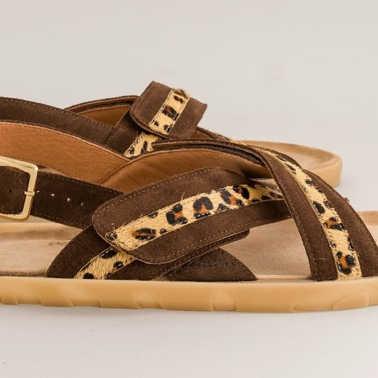 Brown barefoot sandals with leopard print straps on a light gray background