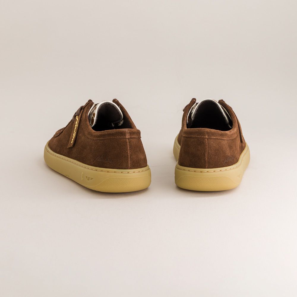 Pair of brown suede barefoot derbies with beige soles on a light gray background
