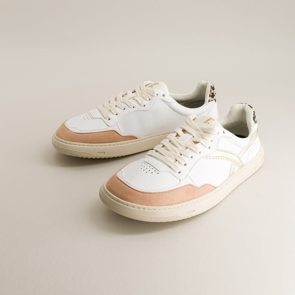 Pair of white and beige barefoot sneakers on a light gray background