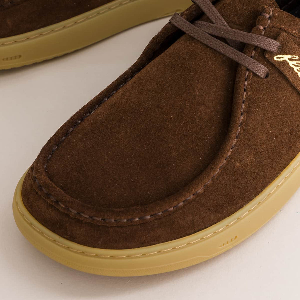 Brown suede derby shoe with a light brown sole on a white background