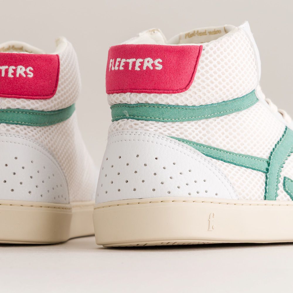 White sneakers with pink and green accents on a light gray background
