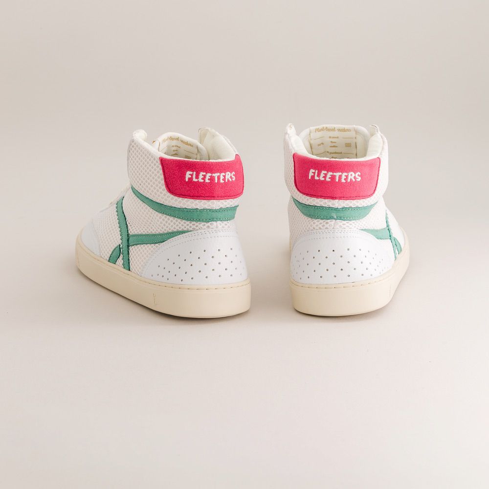White sneakers with pink and green accents on a light gray background