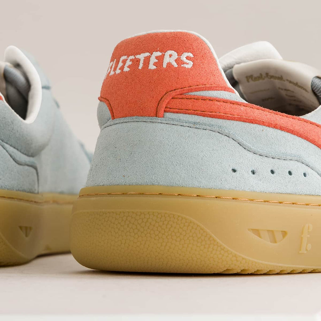 Close-up of a sneaker with 'Fleeters' branding on an off-white background
