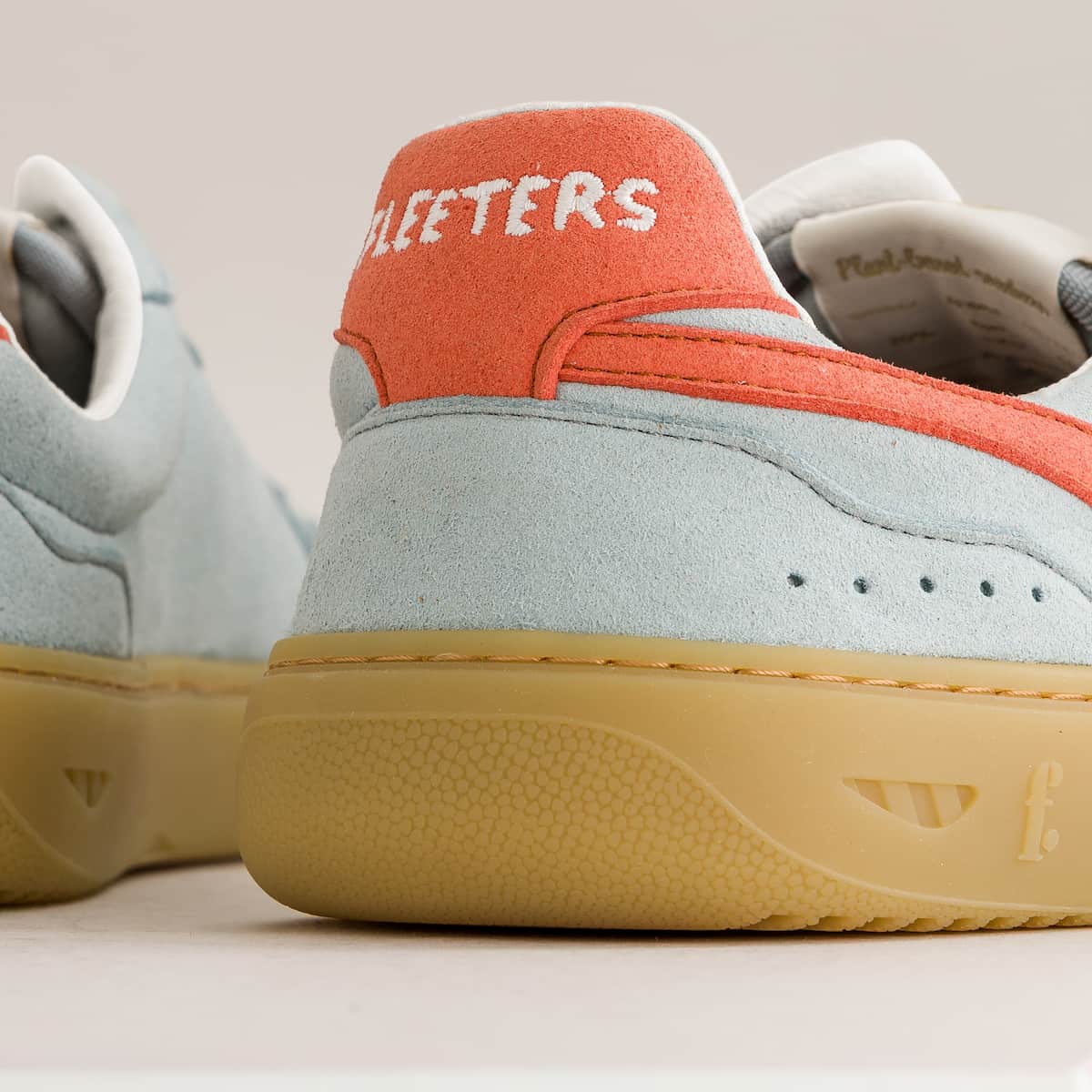 Close-up of a sneaker with 'Fleeters' branding on an off-white background