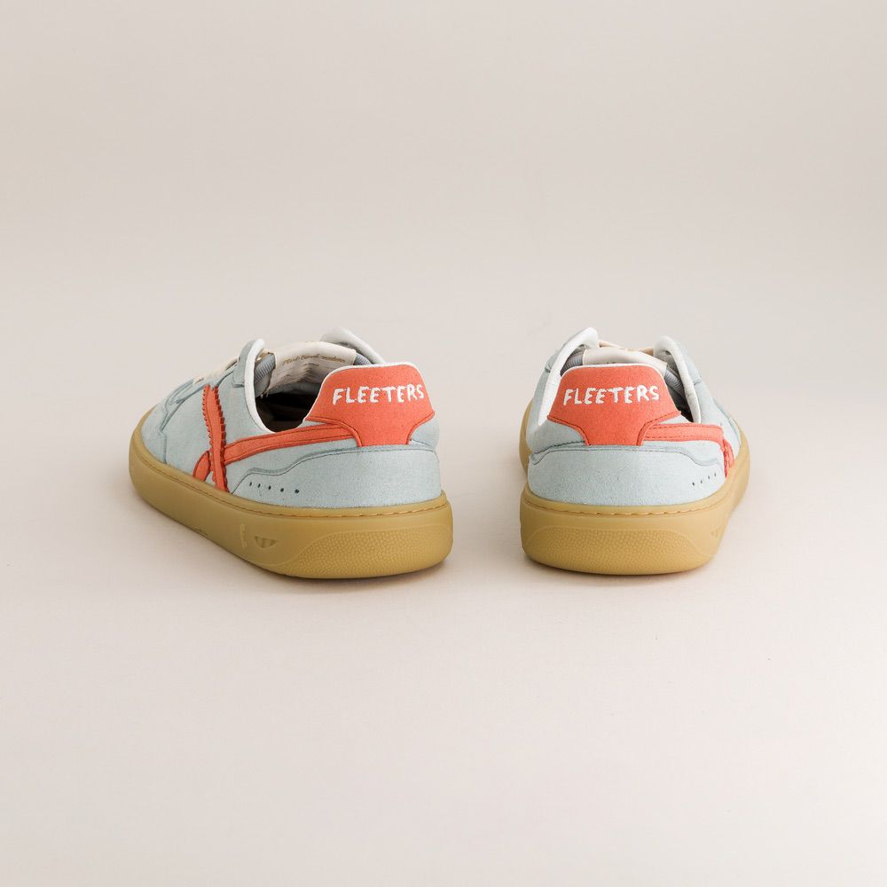 Pair of light blue sneakers with orange accents and 'Fleeters' branding on a beige background