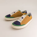 Pair of multicolored barefoot sneakers on a light gray background