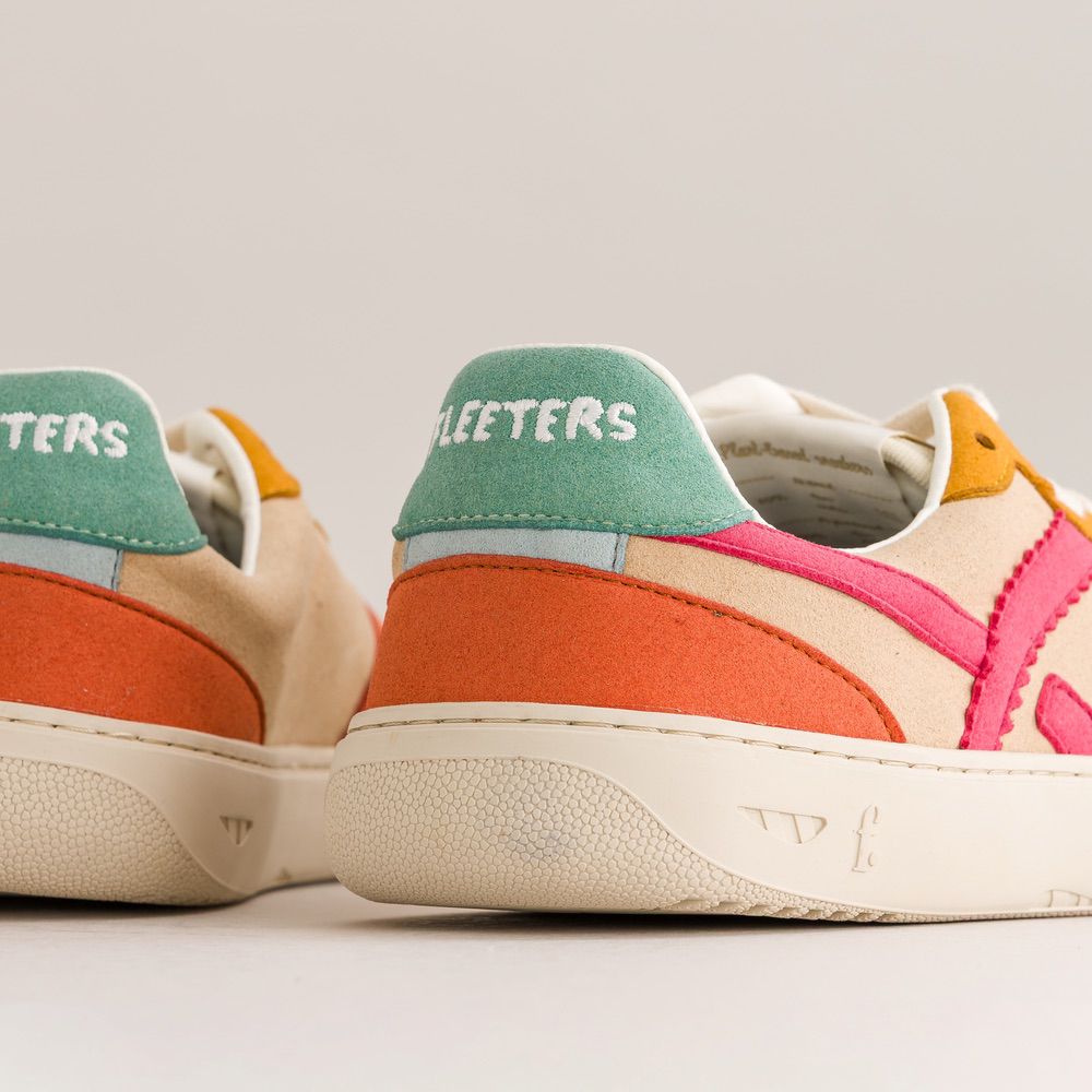 Colorful sneakers with a brand name on a neutral background
