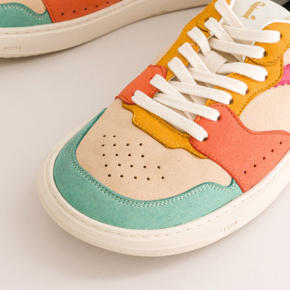 Colorful barefoot sneaker with white laces on a light background