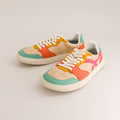 Colorful barefoot sneakers with a heart design on a light gray background