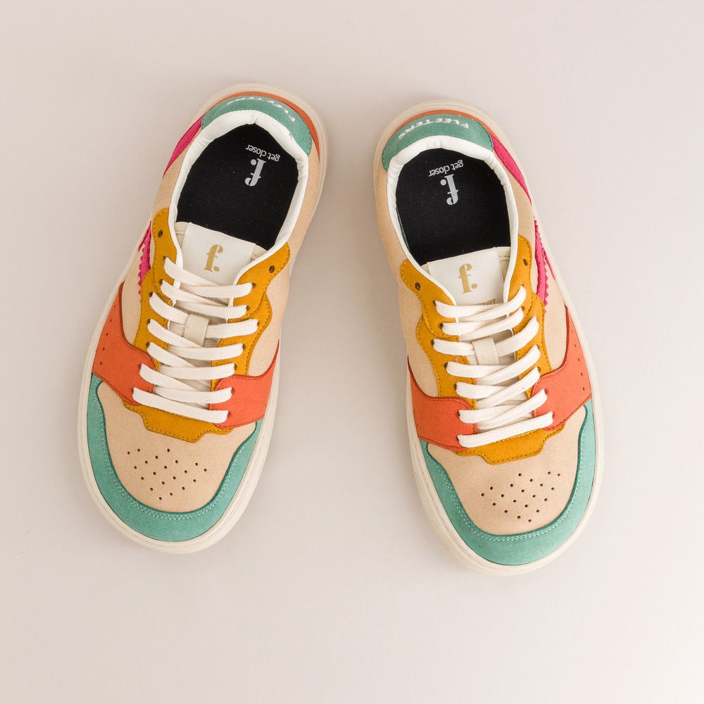 Colorful barefoot sneakers with white laces on a light gray background