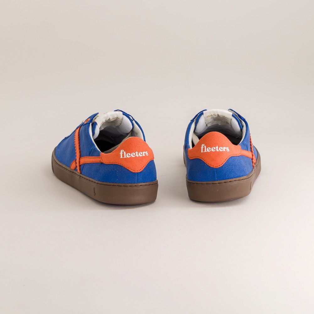 Blue sneakers with orange accents and 'fleeters' branding on a light gray background