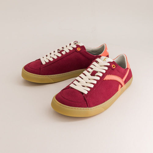 Red barefoot sneakers with white laces on a light gray background