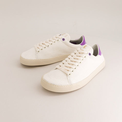 White knit barefoot sneakers with purple accents on a light gray background
