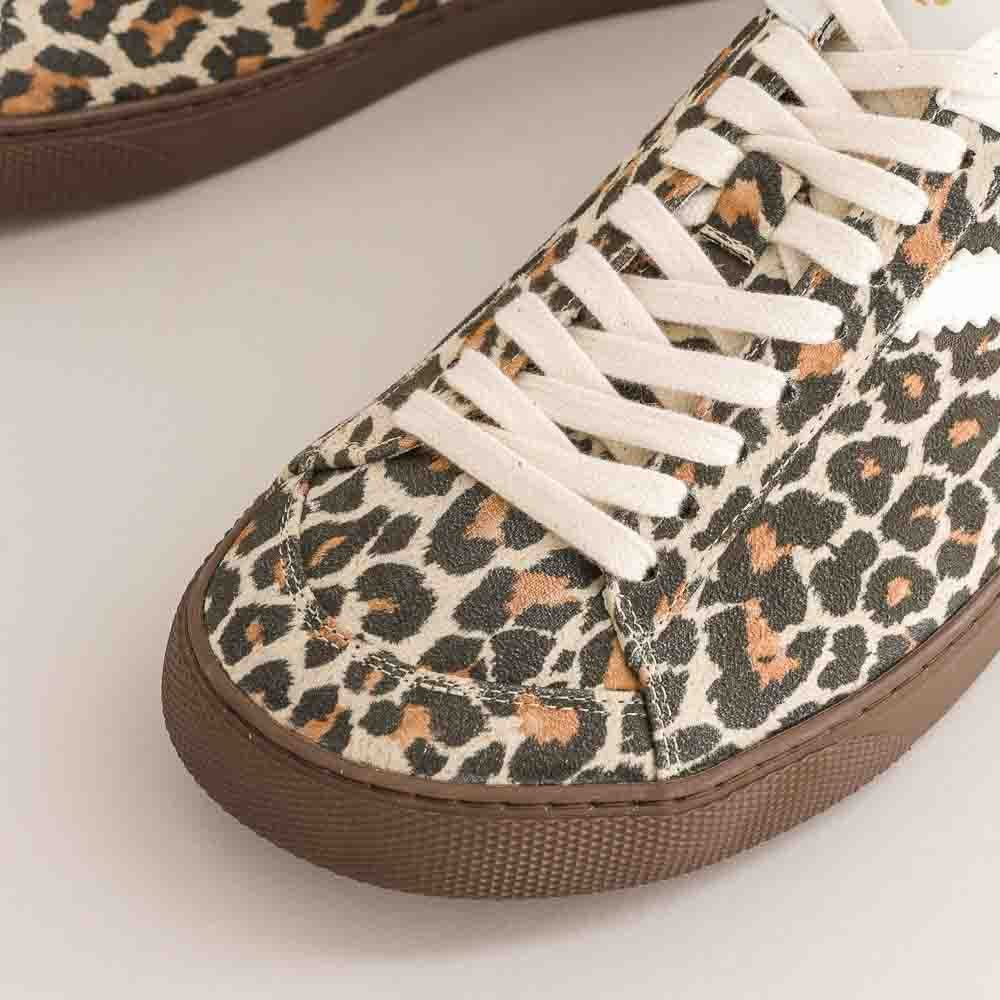 Leopard print barefoot sneaker with white laces on a light background