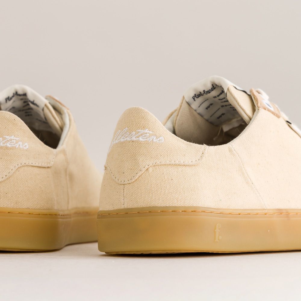 Beige barefoot sneakers with brand name on a light background