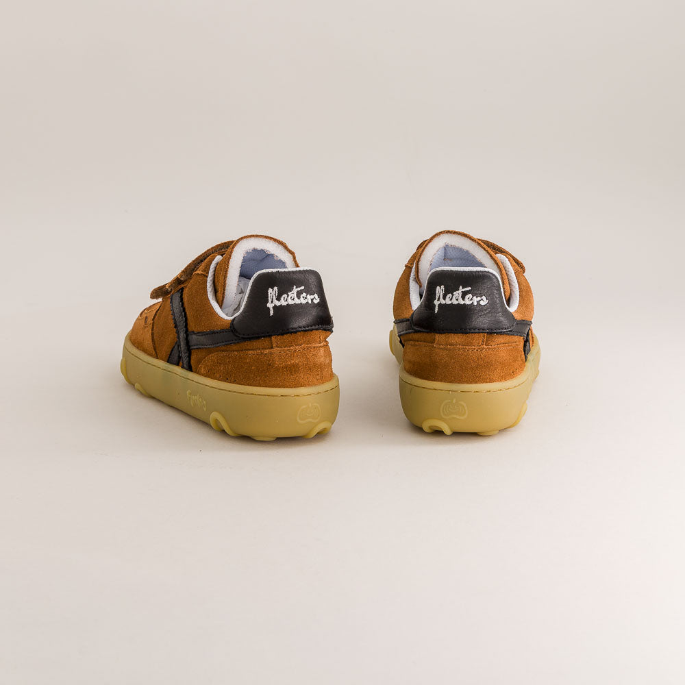 Pair of brown barefoot sneakers with black soles on a light gray background