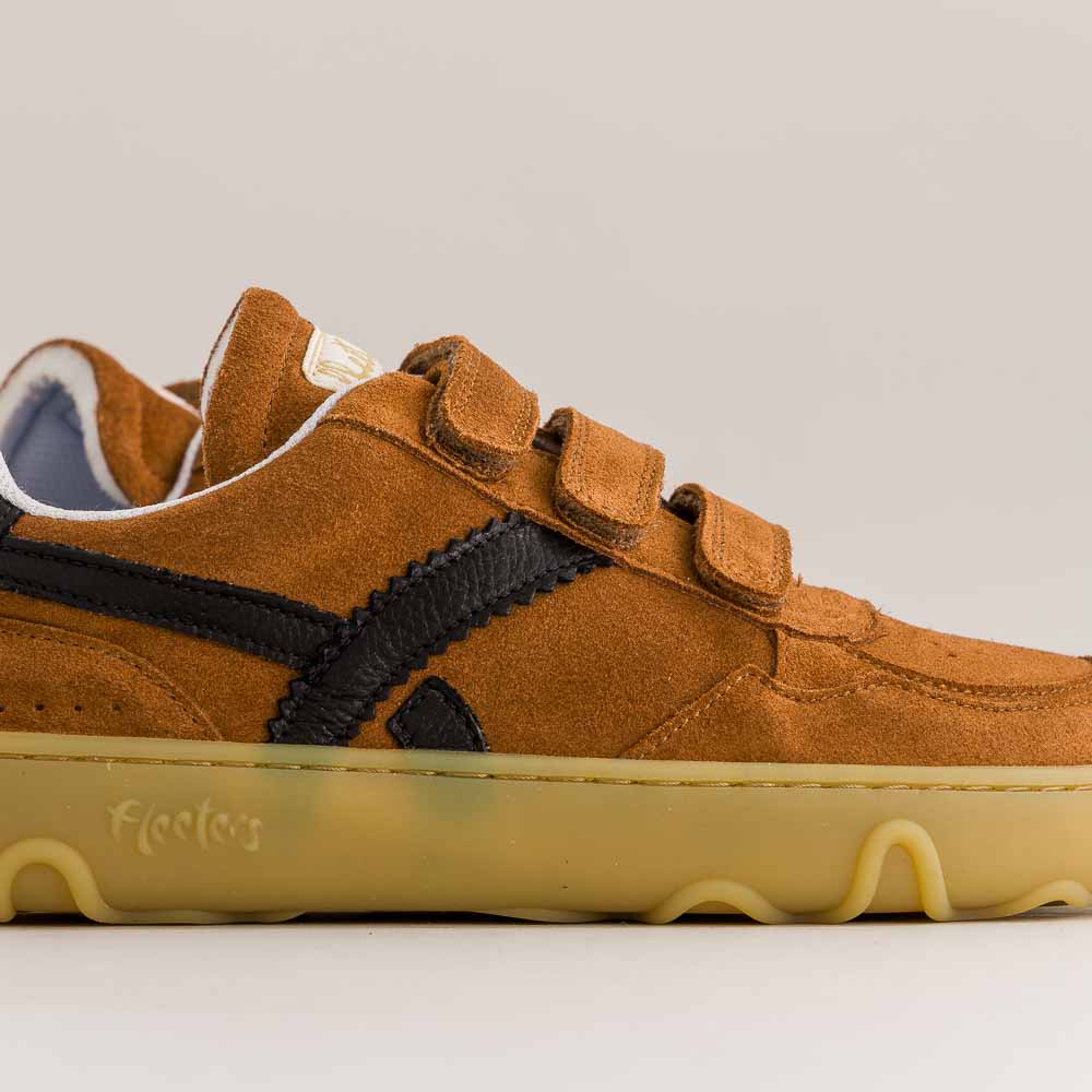 Brown barefoot sneaker with velcro straps on a gray background