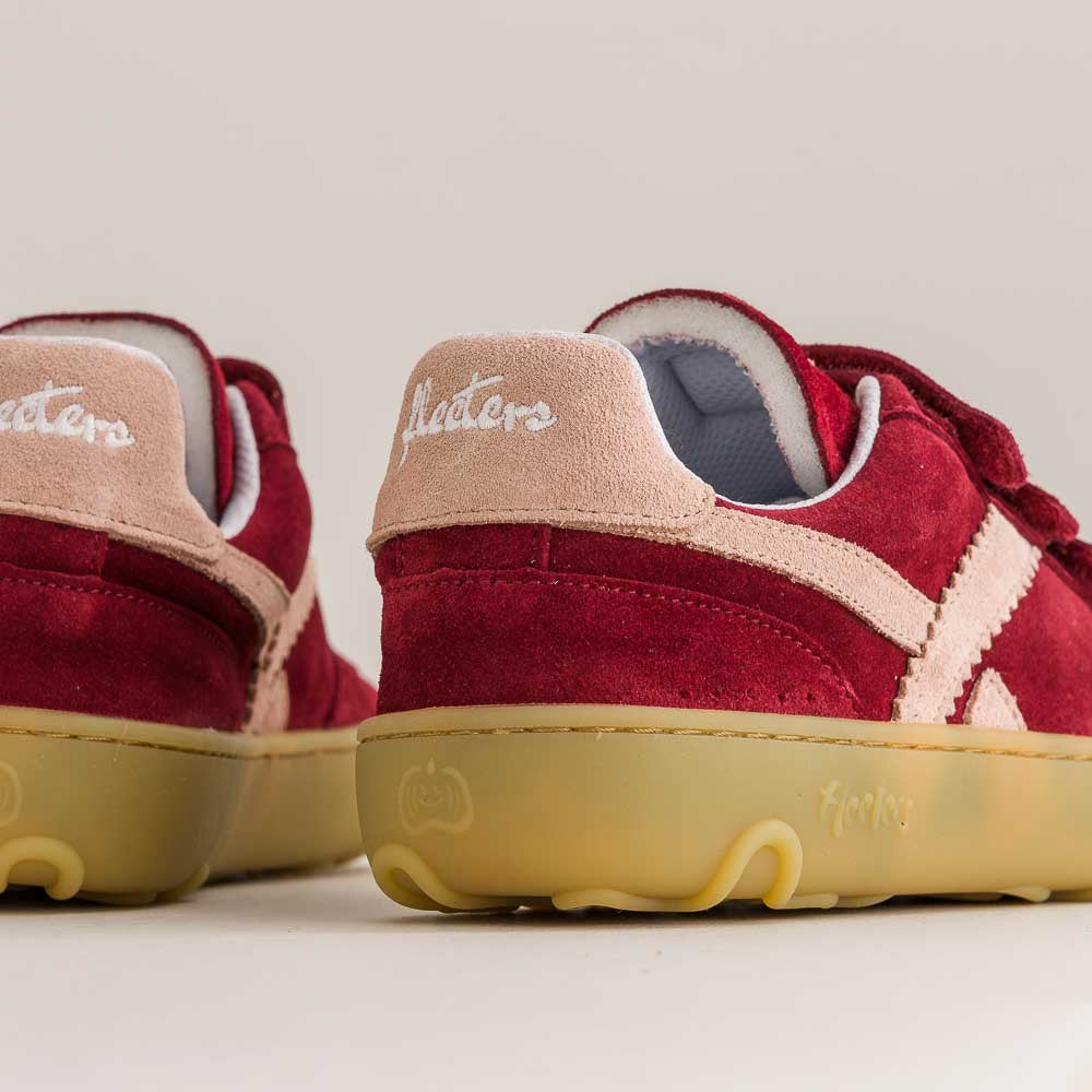 Red barefoot sneakers with beige soles on a light background