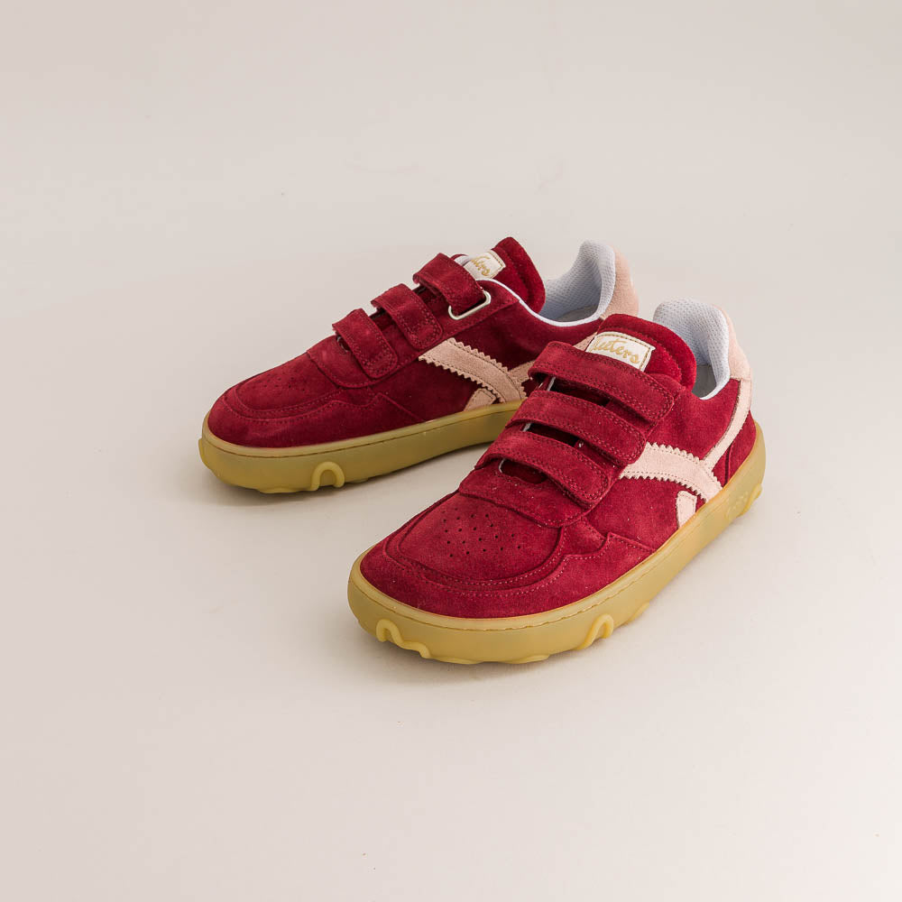 Red children's barefoot sneakers with velcro straps on a light gray background