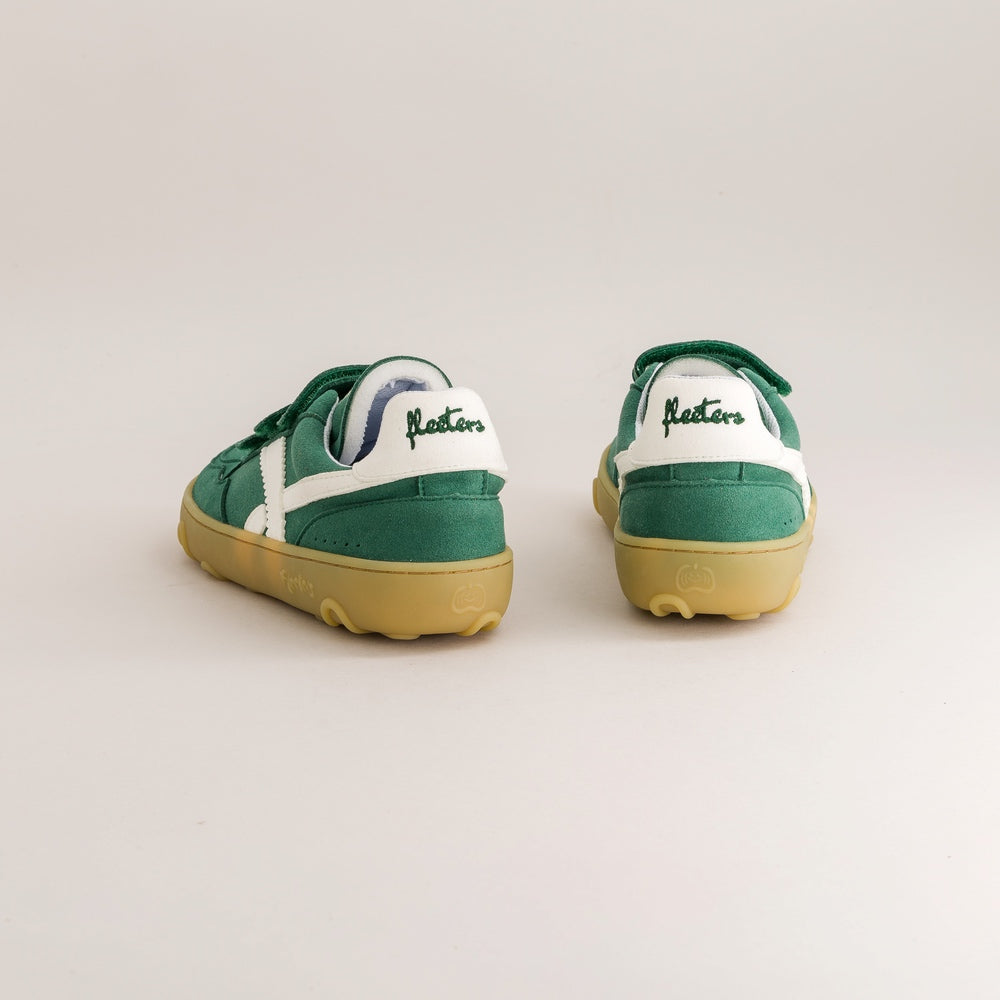 A pair of green and white low-top sneakers shown from the back, featuring a green heel, white heel counter, green laces, and a yellow gum sole. The brand name 'Fleeters' is embroidered in green on the white heel area.