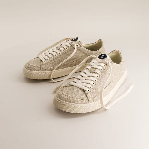 Pair of beige barefoot sneakers in wool with white laces on a light background