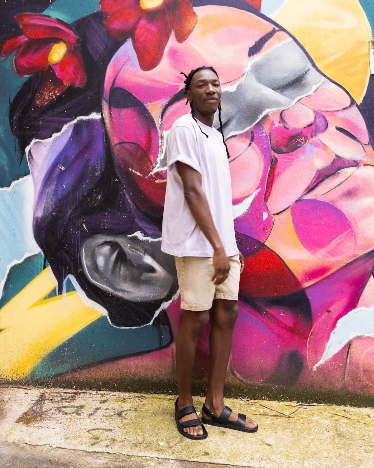 Men wearing barefoot sandals in front of a painted wall