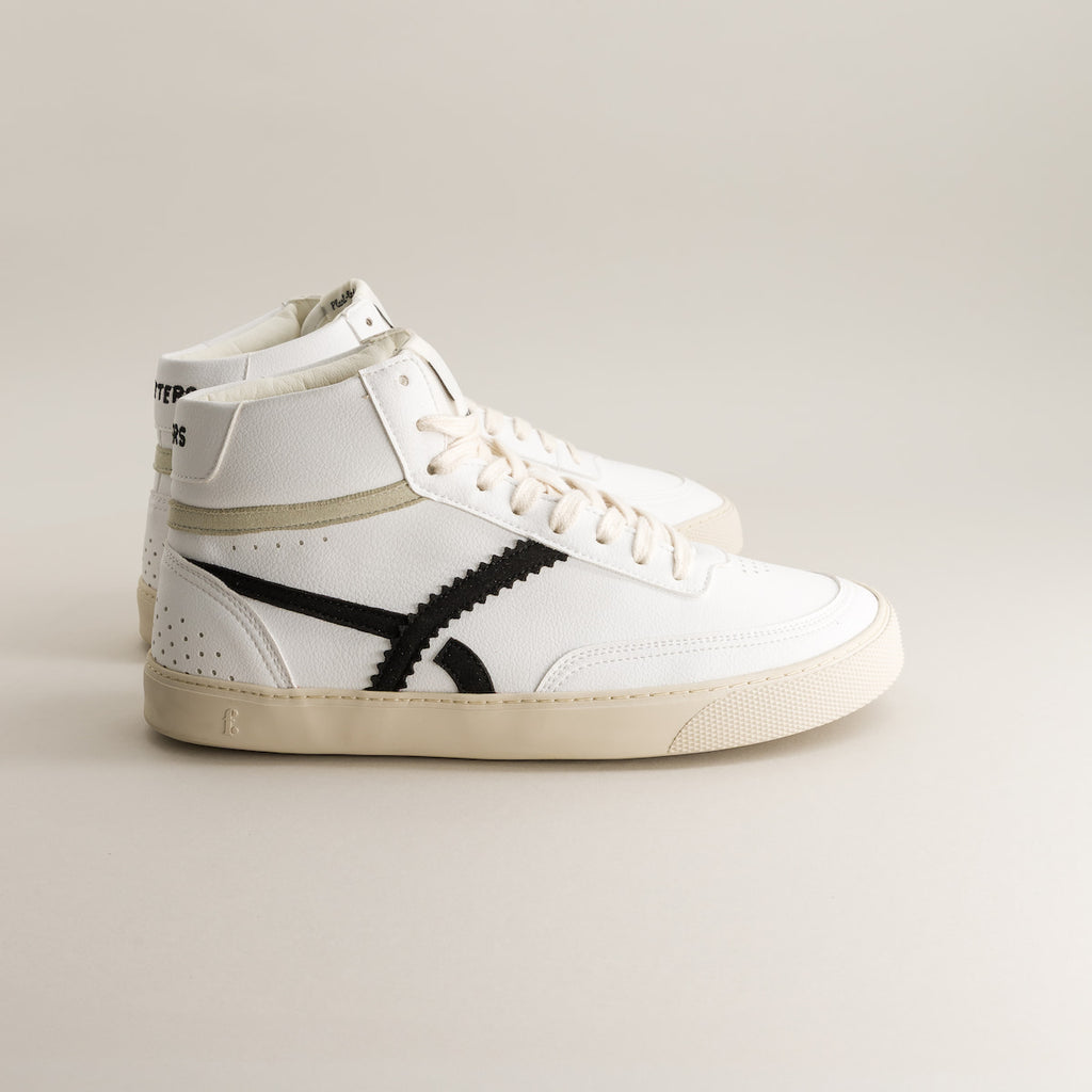 White high-top barefoot sneaker with black design on a light gray background