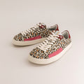 A pair of low-top barefoot canvas sneakers featuring a leopard print pattern, white laces, a pink side stripe, and a burgundy heel tab, displayed on a light gray background.