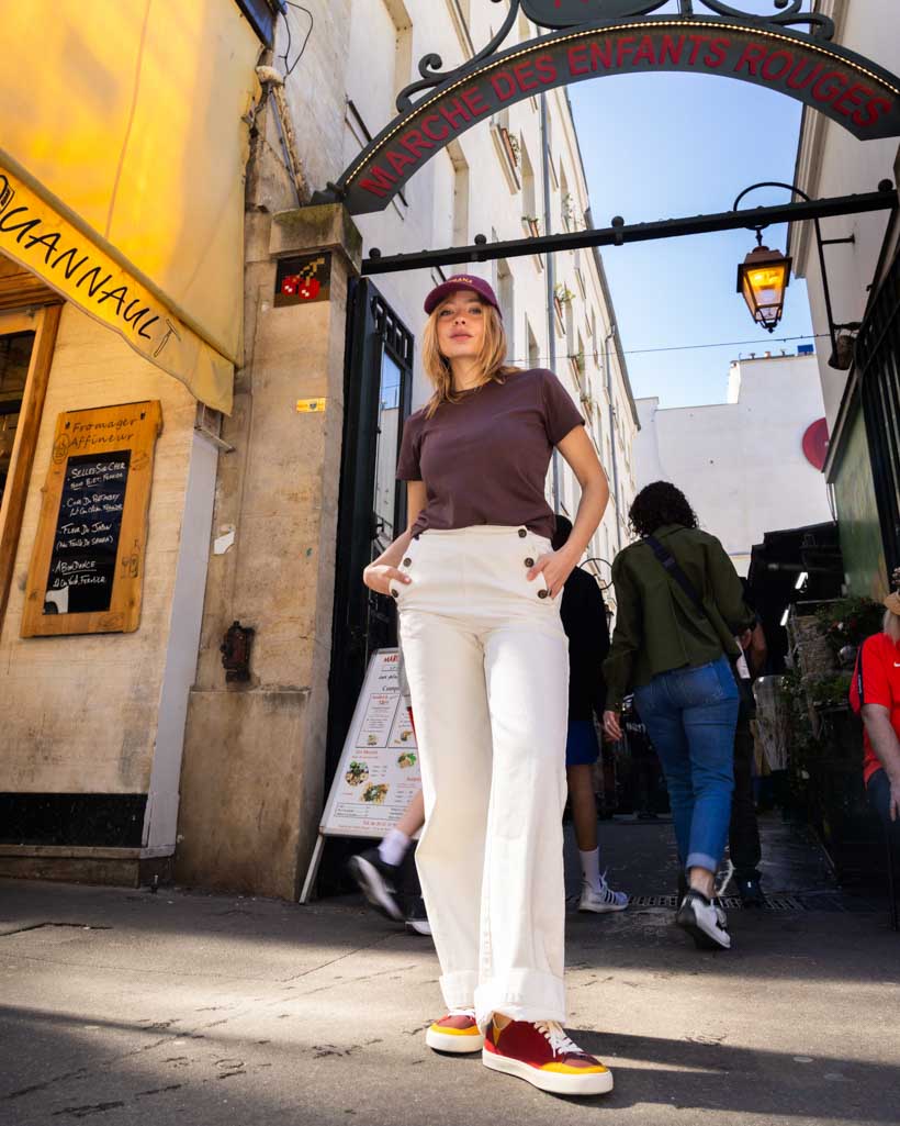 Person standing in an urban street with a store entrance in the background