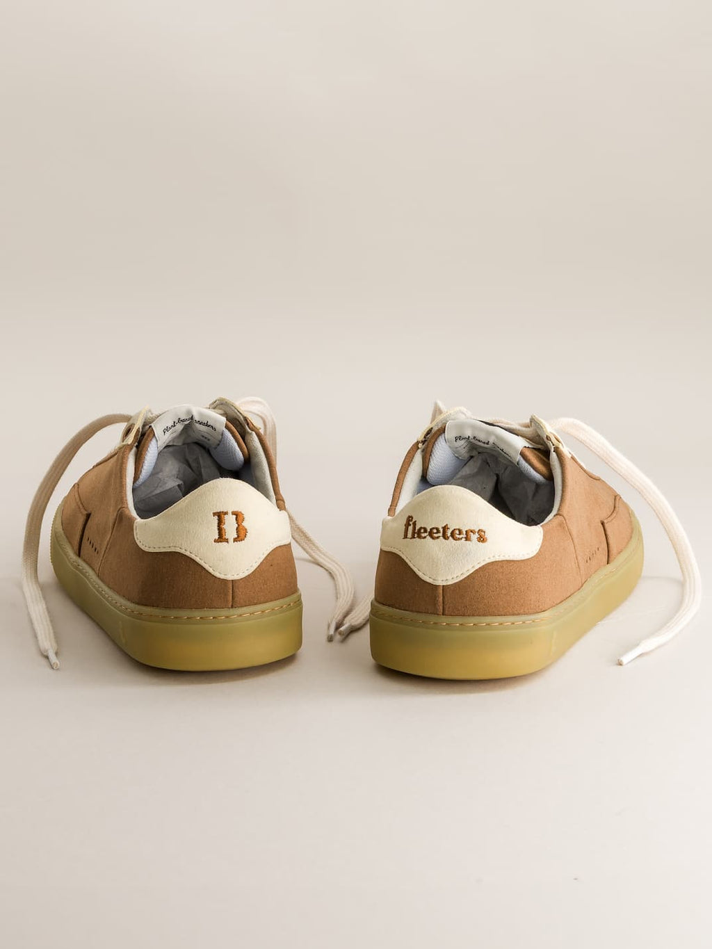 Pair of brown barefoot sneakers with gum soles on a light background