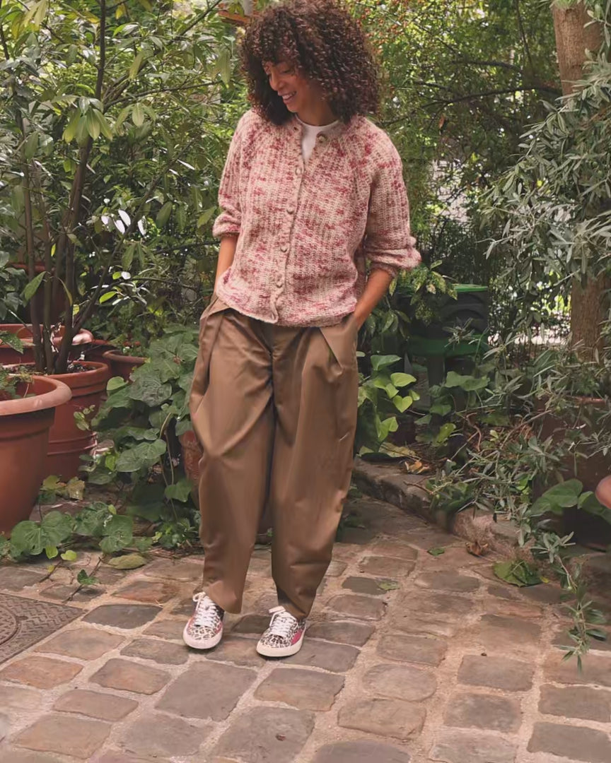 A woman wearing barefoot sneakers, with vegetal background