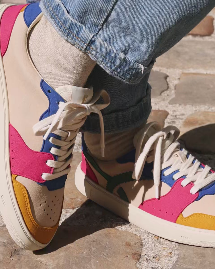 A woman wearing colorful barefoot sneakers
